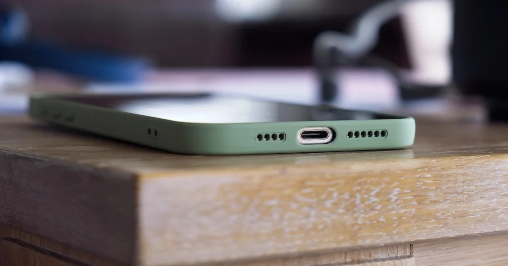 A green smartphone on a table, representing top phone choices for 2025 with expert recommendations and features.