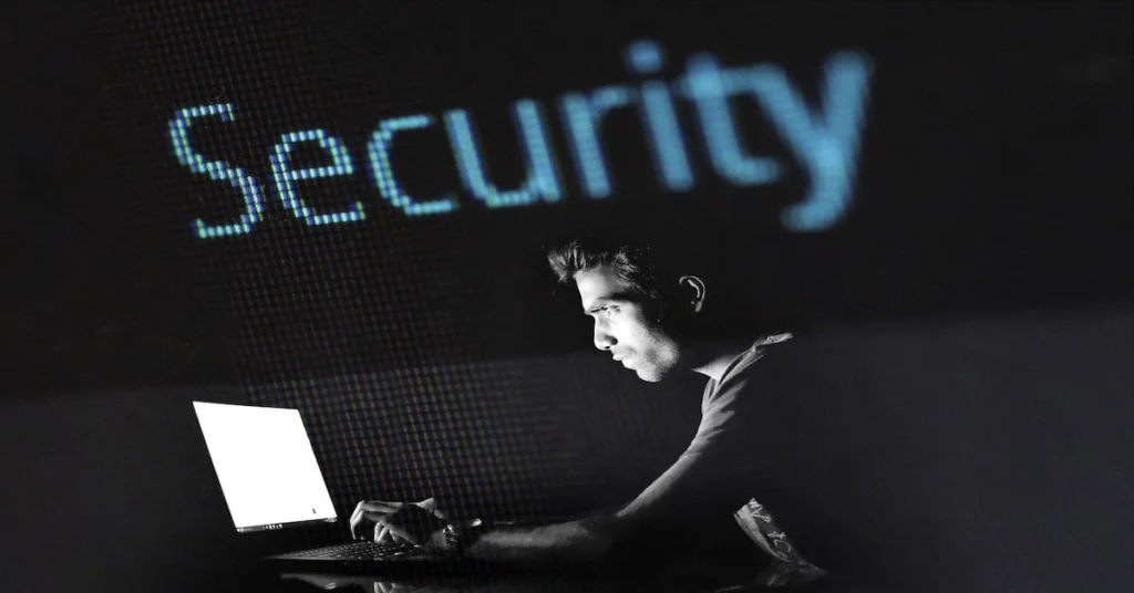 A man at a desk with a laptop, exploring top strategies for protecting digital privacy in 2025.