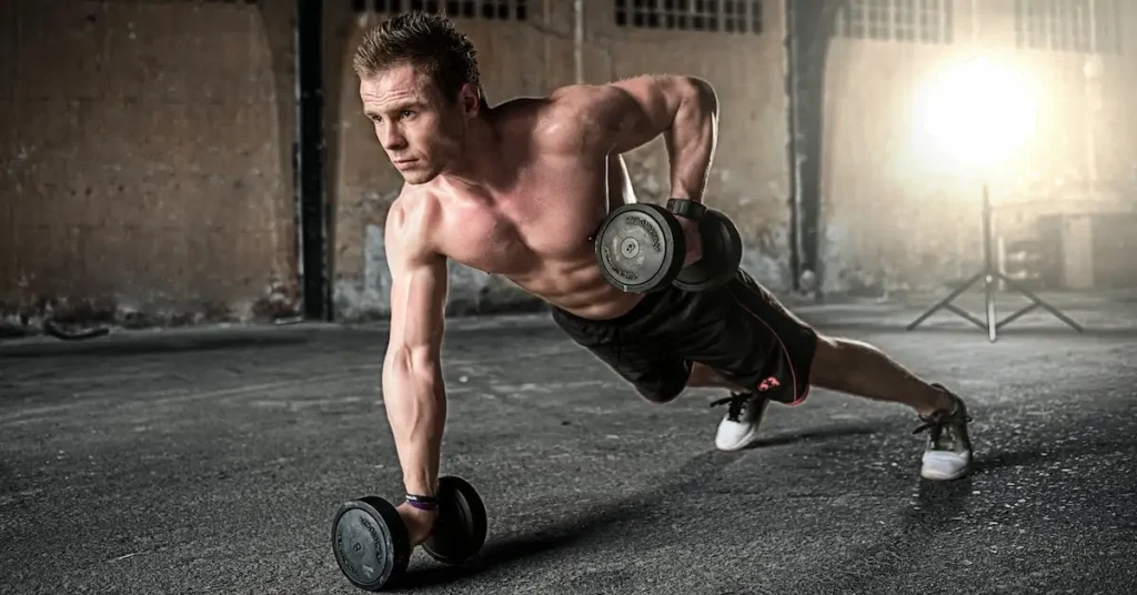 A man performs push-ups with dumbbells, showcasing strength training for fitness and weight loss at home.